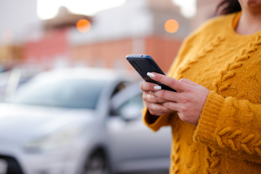 young woman Hispanic crashed with his car using his cell phone. road safety concept