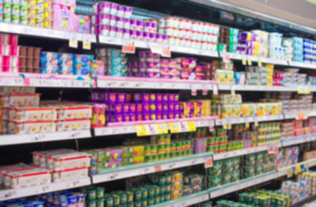 Blurred image of shelves with milk products in supermarket.