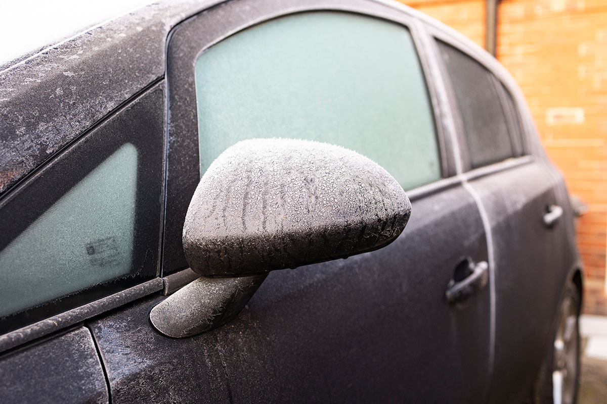 A car is pictured covered in ice during winter conditions.