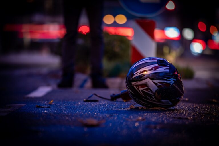 A motorcycle helmet is seen on the ground, symbolizing the aftermath of a motorcycle accident caused by road debris in Ohio.