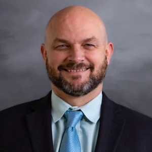 Robert Horton, in a suit and tie, representing Slater & Zurz, smiles confidently for the camera.