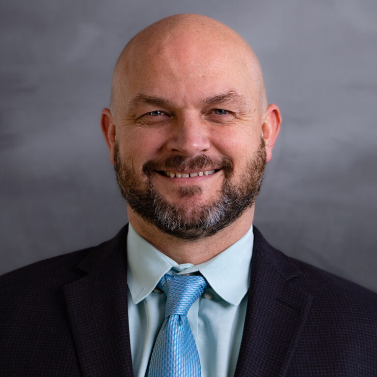 Robert Horton, in a suit and tie, representing Slater & Zurz, smiles confidently for the camera.