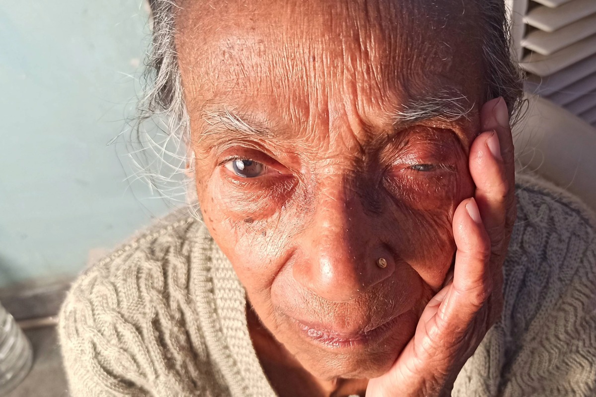 An elderly woman in a nursing home appears stressed with signs of abuse with a swollen eye.