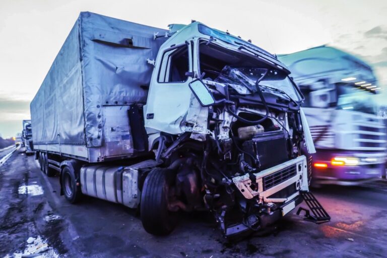 Dramatic highway crash scene of a severely wrecked white semi-truck with front-end destruction and exposed engine on Ohio-like roadway – highlights dangers of truck accidents and need for immediate evidence preservation.