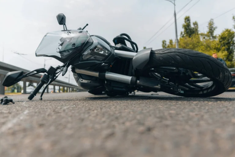 Black motorcycle lying on its side on an Ohio roadway after a crash, illustrating the dangers motorcyclists face during spring riding season.